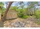 Outdoor storage shed nestled in a wooded area at 2807 Country River Dr, Parrish, FL 34219