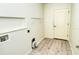 Laundry room with shelving and vinyl plank flooring at 315 Auburn Woods Cir # 315, Venice, FL 34292