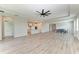 Spacious living room with wood-look floors, kitchen, and dining area at 3519 74Th Avenue E Cir, Sarasota, FL 34243