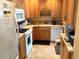 Cozy kitchen with wood cabinets, white appliances, and tile flooring at 390 301 W Blvd # 30B, Bradenton, FL 34205