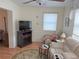 Bright living room featuring comfy seating, a fireplace, and a large TV at 390 301 W Blvd # 30B, Bradenton, FL 34205