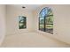 Well-lit bedroom with large windows and carpeted floor at 4927 Windsor Park, Sarasota, FL 34235