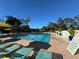 Community lap pool with plenty of lounge chairs at 4927 Windsor Park, Sarasota, FL 34235