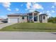 Single-story home with metal roof, white garage door, and landscaped lawn at 5256 Conner Ter, Port Charlotte, FL 33981