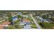 Aerial view showcasing a neighborhood of single-Gathering homes, featuring a pool and green spaces at 6175 Holbrook St, Englewood, FL 34224