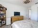 Bedroom with large dresser and flat-screen TV at 6175 Holbrook St, Englewood, FL 34224