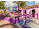 Adorable pink ice cream shop with purple accents and outdoor seating at 6246 Draw Ln # 12, Sarasota, FL 34238