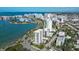Aerial view of waterfront property, showcasing a modern building and marina at 711 S Palm Ave # 203, Sarasota, FL 34236