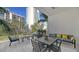 Private balcony with seating area, overlooking a tree-lined park at 711 S Palm Ave # 203, Sarasota, FL 34236