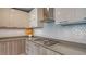 Modern kitchen with gas cooktop and white subway tile backsplash at 711 S Palm Ave # 203, Sarasota, FL 34236