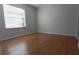 Bright bedroom with wood-look flooring and large window at 7294 Cloister Dr # 8, Sarasota, FL 34231