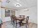 Bright dining room with wood table and chairs, white brick accent wall at 7821 Treasure Pointe Dr, Port Richey, FL 34668