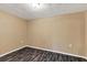 Empty spare bedroom with light brown walls and wood-look flooring at 7821 Treasure Pointe Dr, Port Richey, FL 34668