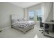 Spacious bedroom with a large bed, desk and two windows at 10214 Crystal Isle Cir, Sarasota, FL 34241