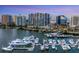 Drone view of luxury marina with many yachts and condo building at 1155 N Gulfstream Ave # 908, Sarasota, FL 34236