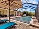 This screened pool and patio includes lounge chairs and an umbrella at 12607 Lake Silver Ave, Bradenton, FL 34211