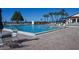 Inviting community pool with surrounding seating at 2055 Gulf Of Mexico Dr # G2-102, Longboat Key, FL 34228