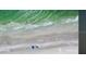 Aerial view of a sandy beach with clear turquoise water and gentle waves at 2141 Clematis St, Sarasota, FL 34239