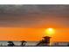 Orange sunset over beach with lifeguard and people enjoying the beach at 2141 Clematis St, Sarasota, FL 34239
