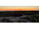 Sunset view from the dunes overlooking the beach, with a colorful horizon and beach grass in the foreground at 2141 Clematis St, Sarasota, FL 34239
