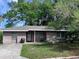 House exterior featuring a single-story home with a gray roof and landscaping at 2141 Clematis St, Sarasota, FL 34239