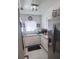 Compact kitchen with stainless steel appliances and white cabinetry, great functionality at 2141 Clematis St, Sarasota, FL 34239