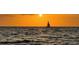 A sailboat is silhouetted on the open water at sunset at 2141 Clematis St, Sarasota, FL 34239