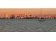 A sailboat resting on the water with the city skyline in the background at dusk at 2141 Clematis St, Sarasota, FL 34239