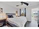 Main bedroom with a king-size bed, plenty of natural light, and access to a private balcony at 2950 Viscaya Pl # 108, Sarasota, FL 34237