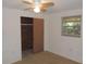 Bedroom with a large closet and ceiling fan at 3245 Roxbury Dr, Holiday, FL 34691