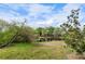 Lush backyard view of a pond, offering a serene natural setting, community homes in background at 3415 51St Avenue W Cir # 206, Bradenton, FL 34210
