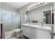 Bathroom with double vanity, shower, and frosted glass enclosure at 3415 51St Avenue W Cir # 206, Bradenton, FL 34210