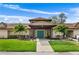 Inviting clubhouse entrance featuring a covered entryway, blue doors, and a well-manicured lawn with palm trees at 3415 51St Avenue W Cir # 206, Bradenton, FL 34210