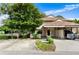 Tan home with a carport, driveway, and mature landscaping, including vibrant green trees at 3415 51St Avenue W Cir # 206, Bradenton, FL 34210