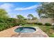 Outdoor hot tub surrounded by brick pavers and lush landscaping, offering privacy and relaxation at 3415 51St Avenue W Cir # 206, Bradenton, FL 34210