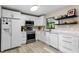 Modern white kitchen with stainless steel appliances and quartz countertops at 3415 51St Avenue W Cir # 206, Bradenton, FL 34210