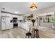 Bright kitchen features white cabinets, stainless steel appliances, and light wood flooring at 3415 51St Avenue W Cir # 206, Bradenton, FL 34210