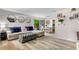 Open concept living room and dining area with L-shaped sofa at 3415 51St Avenue W Cir # 206, Bradenton, FL 34210