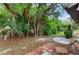Relaxing patio with table and chairs, nestled amongst lush tropical foliage at 3415 51St Avenue W Cir # 206, Bradenton, FL 34210