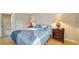 Bedroom with full bed, nightstands, and access to the bathroom at 3609 59Th W Ave # 4045, Bradenton, FL 34210
