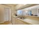 Updated kitchen with white cabinetry, double sink, and view to dining area at 3609 59Th W Ave # 4045, Bradenton, FL 34210