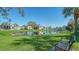 Serene lake view with a bench, perfect for relaxation at 3609 59Th W Ave # 4045, Bradenton, FL 34210