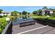 Community deck overlooking a pond with a bench, offering a relaxing view at 3609 59Th W Ave # 4045, Bradenton, FL 34210