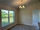 Bright dining room with a chandelier and a view of the backyard at 378 Rallus Rd, Venice, FL 34293