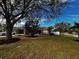 House with large tree and well-manicured lawn at 4152 Banbury Cir, Parrish, FL 34219