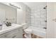 Updated bathroom with gray vanity and marble-look shower/tub combo at 4444 Swift Rd # 13, Sarasota, FL 34231