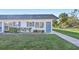 White single story home with blue door and walkway at 4444 Swift Rd # 13, Sarasota, FL 34231