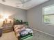 Bedroom with a twin bed, dresser and window at 448 Park Trace Blvd, Osprey, FL 34229