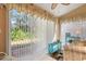 Sunroom with sliding doors and view of the garden at 4727 Tivoli Ave, Sarasota, FL 34235