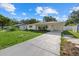 Newly renovated house with a carport and a spacious grassy lawn at 5315 24Th St W, Bradenton, FL 34207